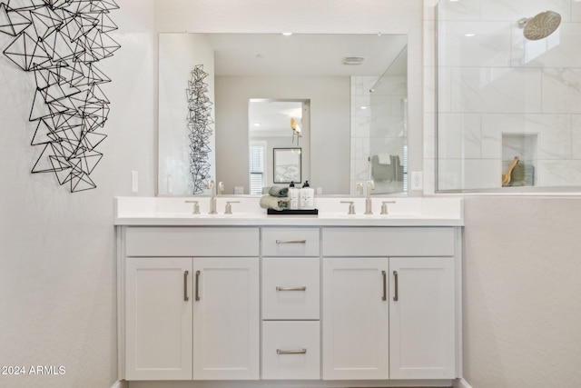 bathroom with vanity and tiled shower