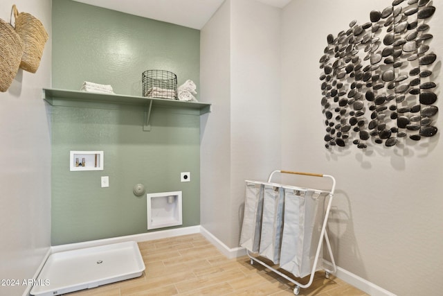 washroom with electric dryer hookup, hookup for a washing machine, hookup for a gas dryer, and hardwood / wood-style floors