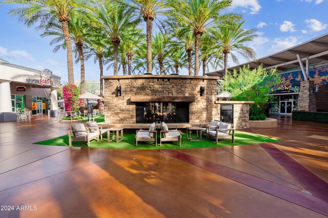 view of patio / terrace with an outdoor living space with a fireplace