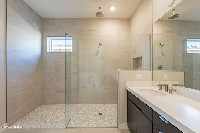 bathroom featuring vanity and tiled shower