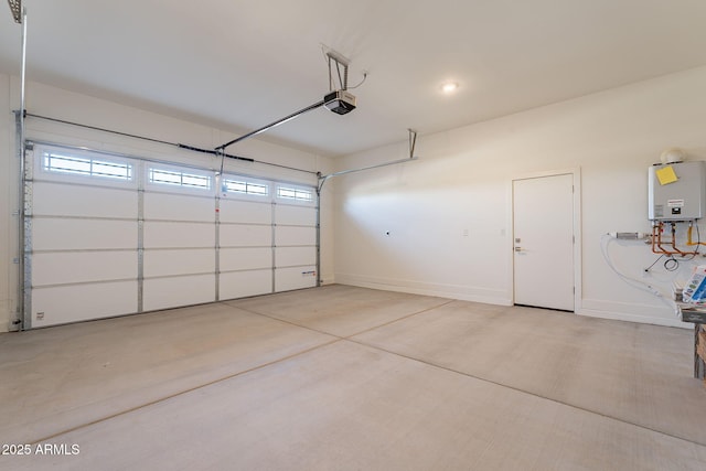 garage featuring tankless water heater and a garage door opener