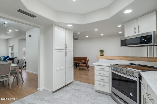 3204 N Jay St, Chandler, AZ 85225 - kitchen featuring stainless steel appliances, white cabinetry, recessed lighting, light stone counters, and open floor plan