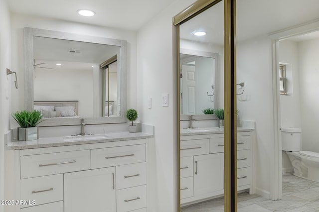 3204 N Jay St, Chandler, AZ 85225 - full bath with two vanities, marble look tiles, recessed lighting, and a ceiling fan