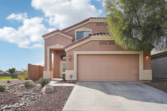 mediterranean / spanish-style home with a garage