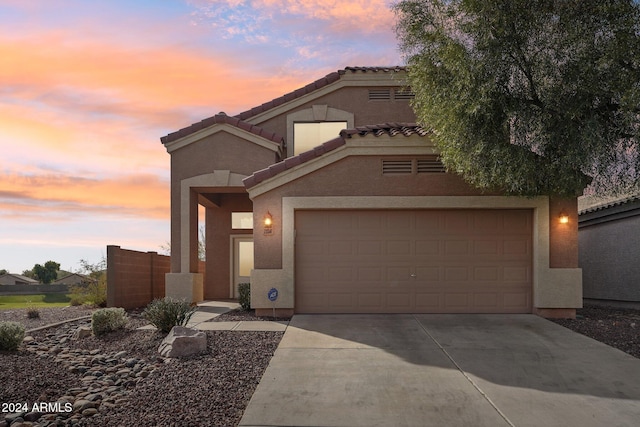 mediterranean / spanish-style home with a garage