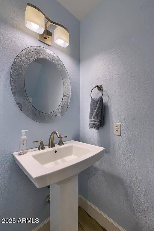 bathroom with sink and hardwood / wood-style flooring