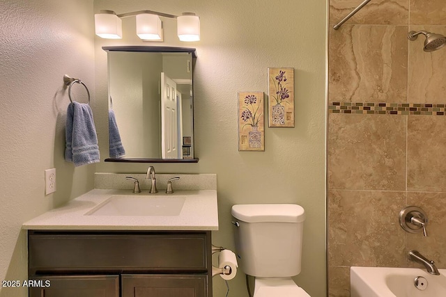 full bathroom featuring vanity, toilet, and tiled shower / bath