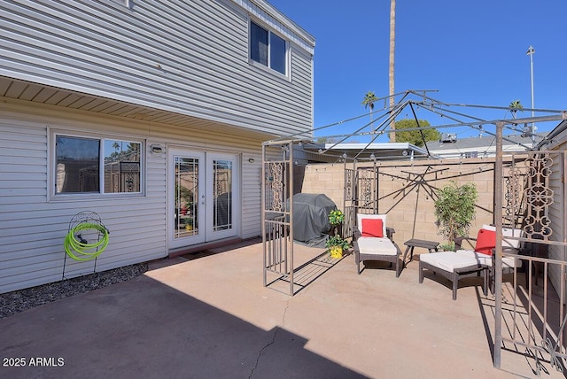 view of patio / terrace with area for grilling and french doors