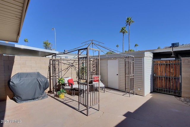 view of patio with a grill and a storage shed