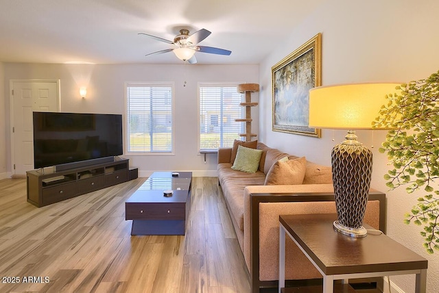 living room with ceiling fan and light hardwood / wood-style floors