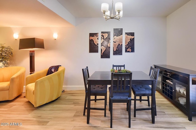 dining room with a notable chandelier and light wood-type flooring