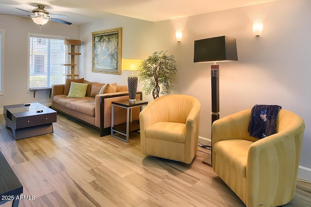 living room with ceiling fan and light hardwood / wood-style floors