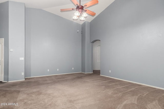 carpeted spare room with high vaulted ceiling and ceiling fan