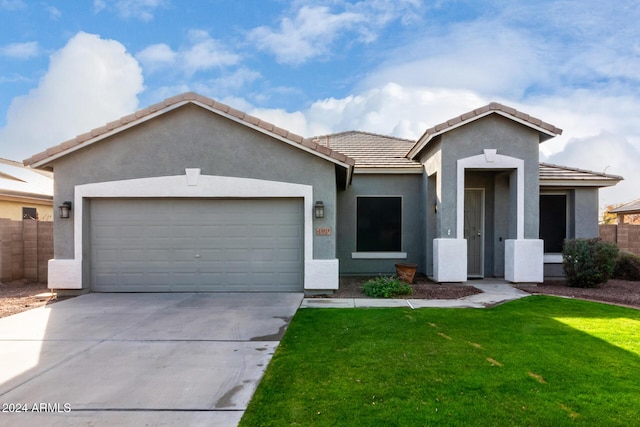 view of front of property with a front yard and a garage