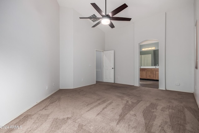 unfurnished room featuring carpet, ceiling fan, and high vaulted ceiling