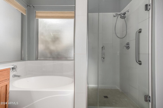 bathroom featuring separate shower and tub