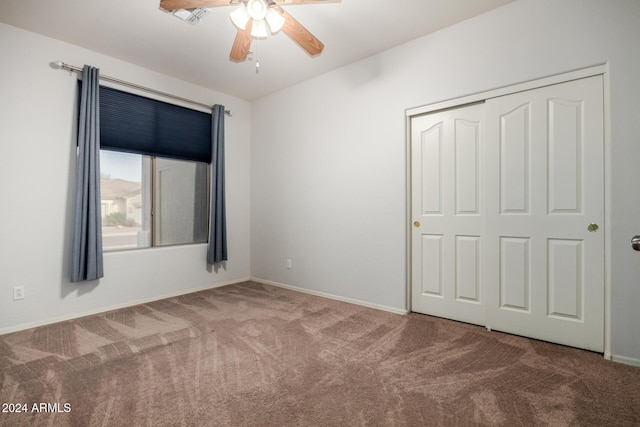 unfurnished bedroom featuring ceiling fan, a closet, and carpet floors