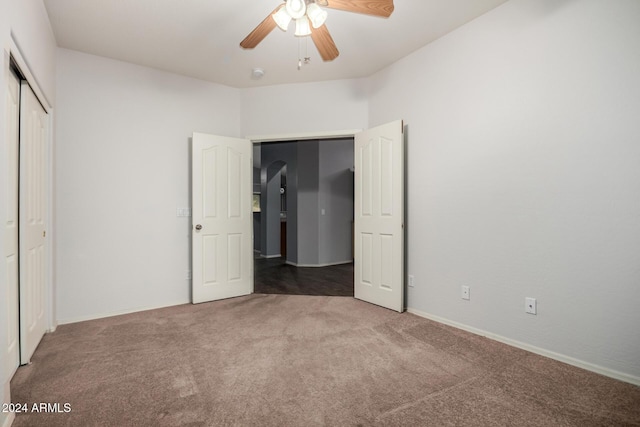 unfurnished bedroom with ceiling fan, carpet, and a closet