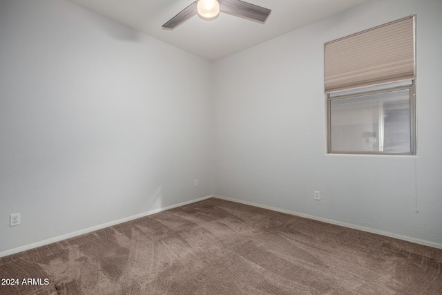 unfurnished room featuring ceiling fan and carpet