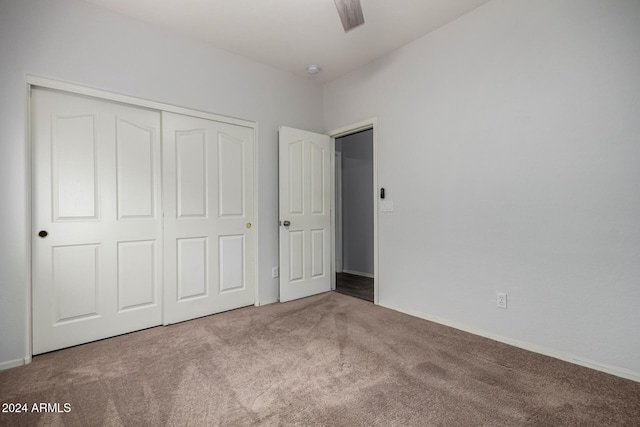 unfurnished bedroom featuring ceiling fan, a closet, and carpet flooring