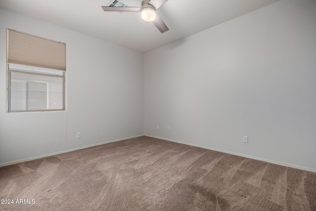 carpeted empty room featuring ceiling fan