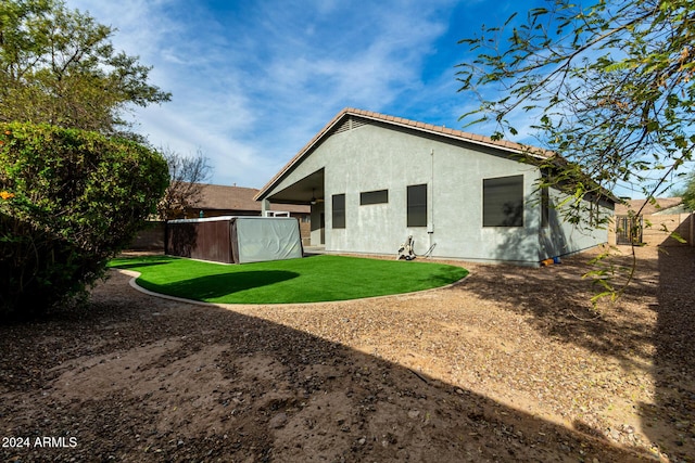 rear view of property with a yard