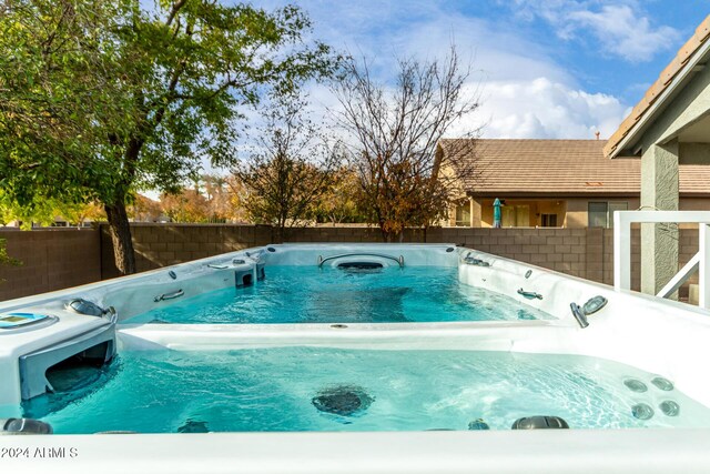 view of pool with a hot tub