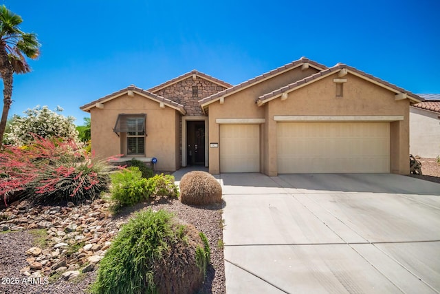 view of front of home featuring stucco siding, an attached garage, stone siding, driveway, and a tiled roof