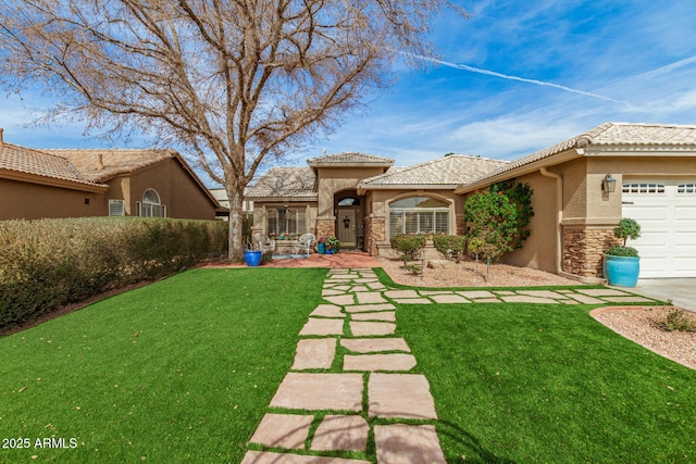 exterior space featuring an attached garage, stone siding, a tiled roof, stucco siding, and a front lawn