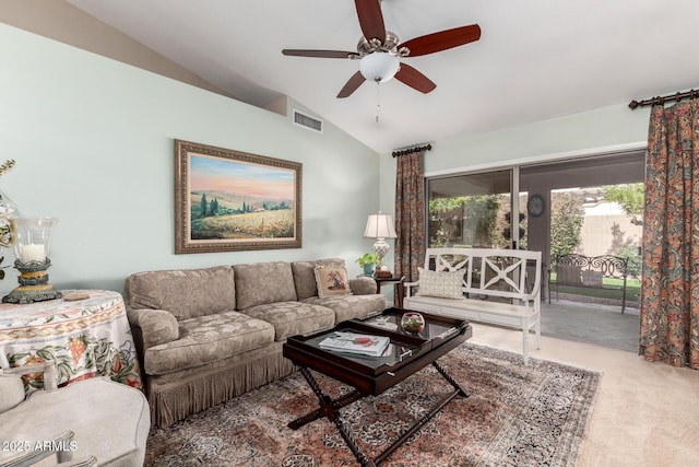 living area featuring vaulted ceiling, carpet, visible vents, and a ceiling fan