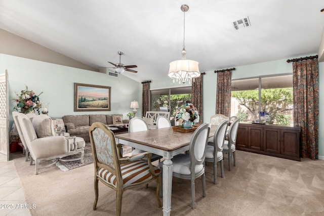 dining room featuring lofted ceiling, light tile patterned floors, visible vents, and a healthy amount of sunlight