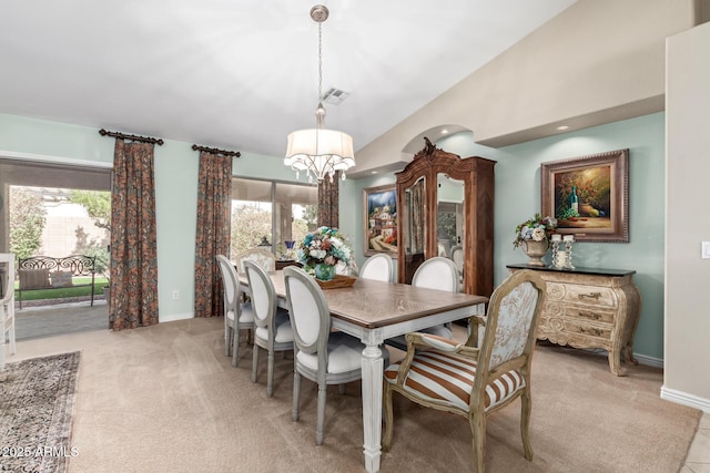 dining space featuring visible vents, baseboards, light colored carpet, lofted ceiling, and a notable chandelier