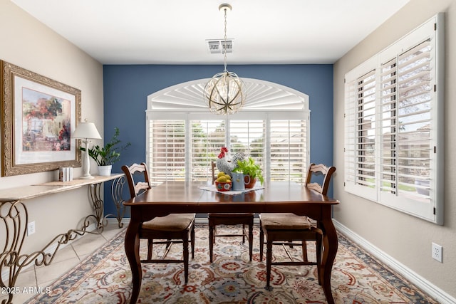 dining room with light tile patterned floors, baseboards, visible vents, and an inviting chandelier