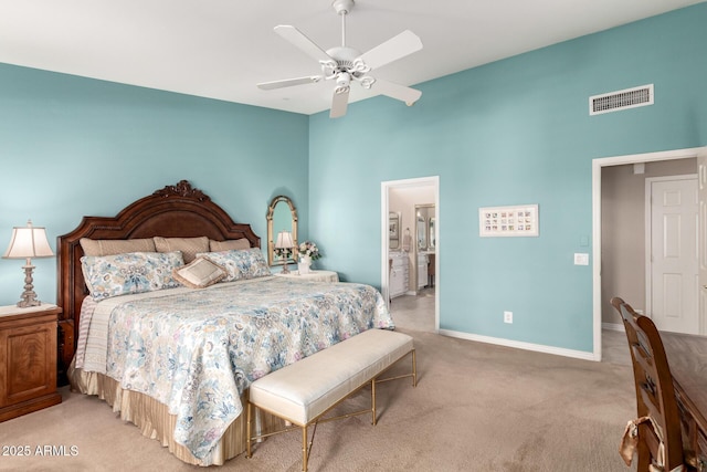 bedroom featuring ceiling fan, light colored carpet, a towering ceiling, baseboards, and visible vents