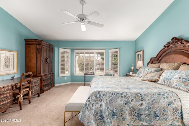 bedroom featuring a ceiling fan, light colored carpet, vaulted ceiling, and baseboards