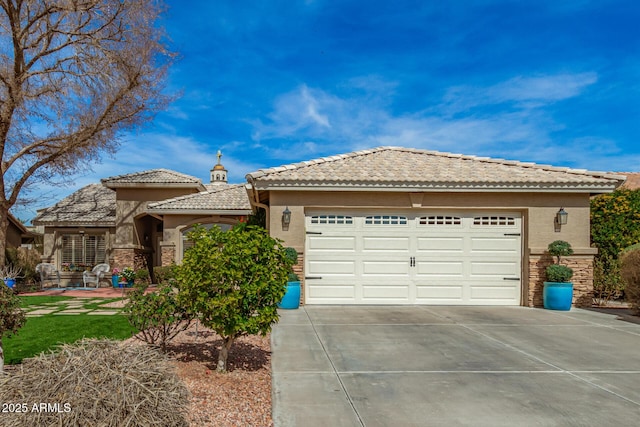 view of front of house with stone siding, driveway, a tiled roof, and stucco siding