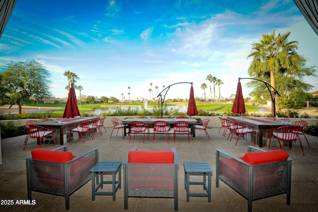 view of patio / terrace featuring a water view and outdoor dining space