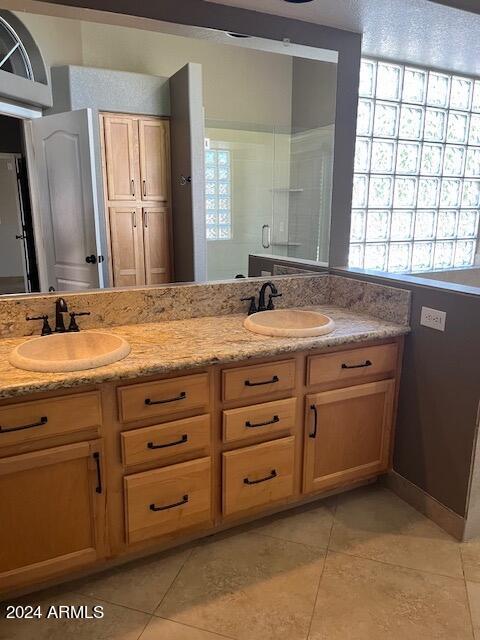 bathroom featuring plenty of natural light, tile patterned floors, and vanity