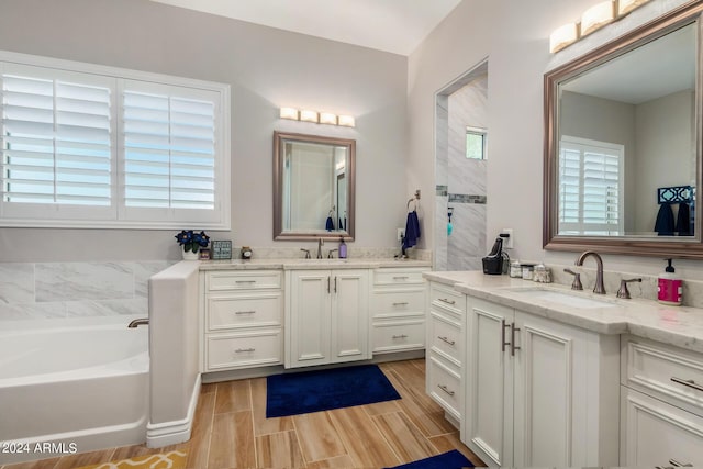 bathroom with vanity and a tub to relax in