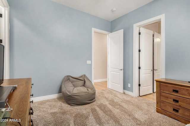 sitting room featuring light carpet