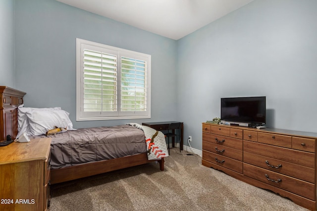 bedroom with vaulted ceiling and light carpet