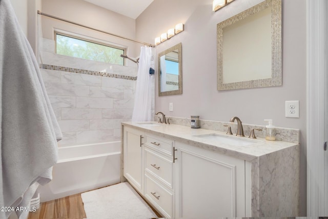 bathroom with hardwood / wood-style flooring, shower / bath combo, and vanity