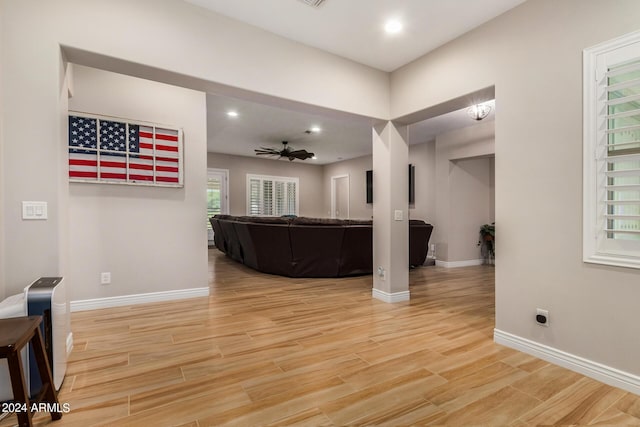 living room with light hardwood / wood-style floors and ceiling fan