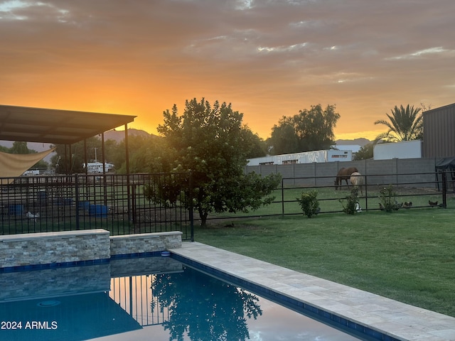 pool at dusk with a lawn