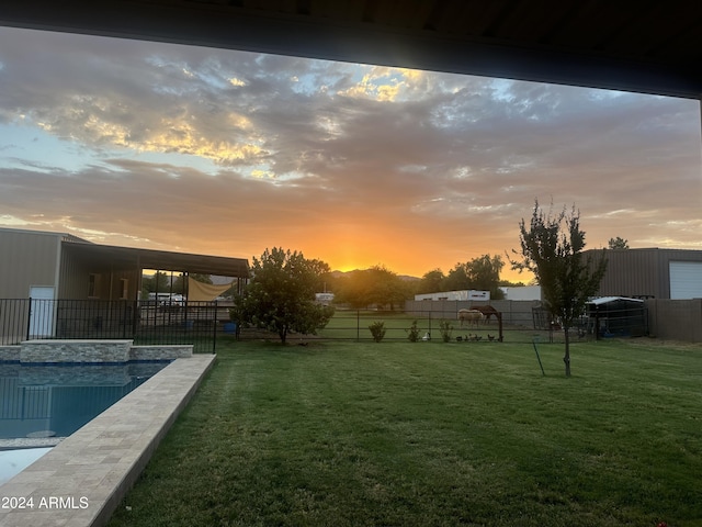 yard at dusk featuring a fenced in pool