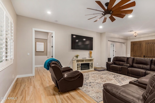 living room with ceiling fan and light hardwood / wood-style floors