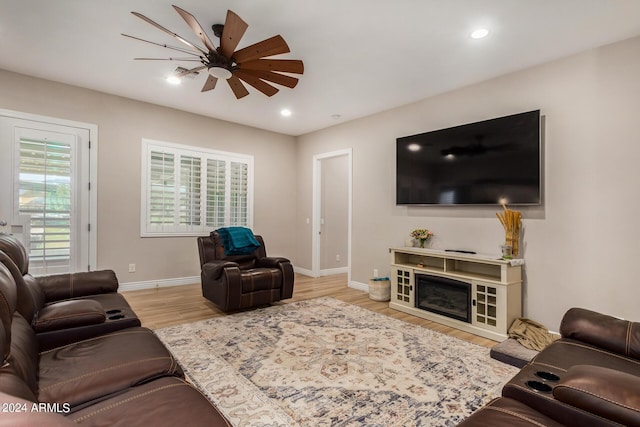 living room with ceiling fan and light wood-type flooring