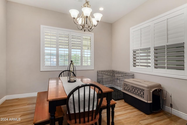 dining area with a notable chandelier and light hardwood / wood-style flooring