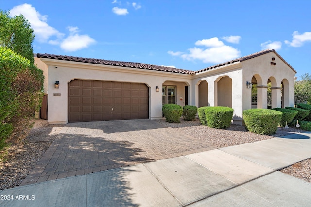 mediterranean / spanish house featuring a garage