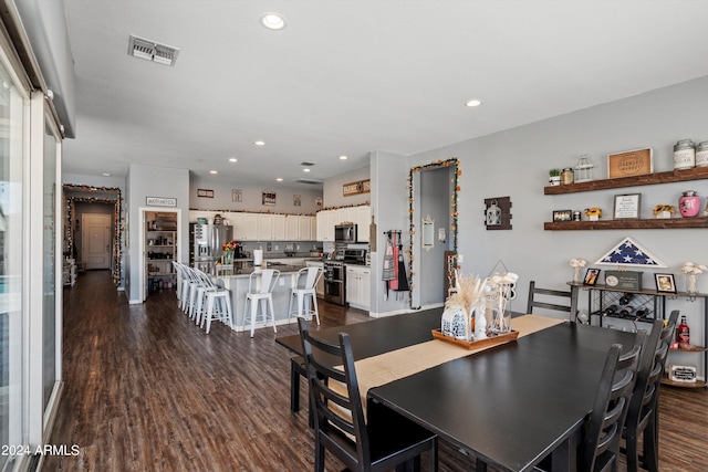 dining area with dark hardwood / wood-style floors